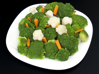 broccoli, cauliflower and carrots on black