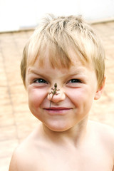 The boy with the lizard on a nose