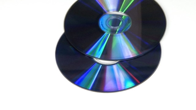 Blue CD DVD rotating on white background