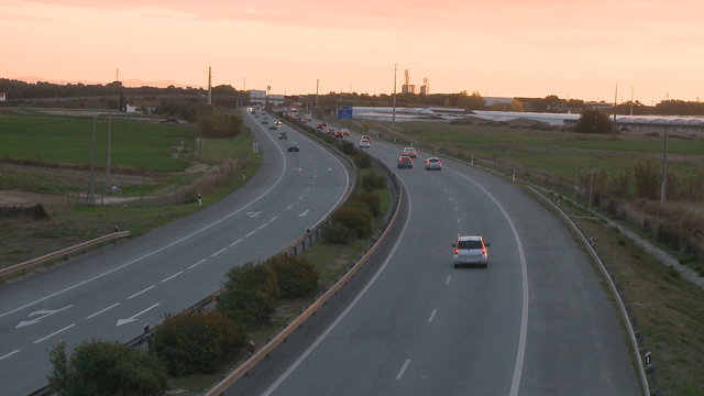 Cars time lapse on highway at sunset