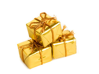Small golden gifts, isolated over white.
