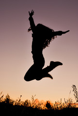 silhouette of young woman jumping