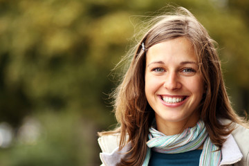 Fototapeta premium Closeup portrait of a happy young woman smiling