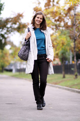 Fototapeta premium Beautiful young woman in autumn park