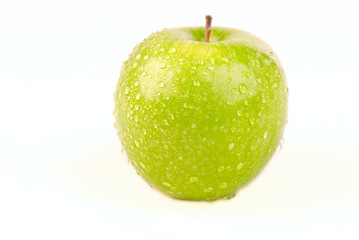Green apple with water drops on white background