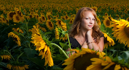 Beautiful women in sunflowers fiel