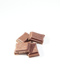 bits of tasty chocolate isolated on white
