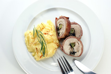 mashed potato and chicken roll on a white plate