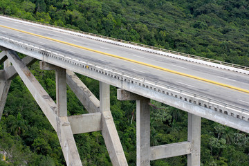 Fototapeta premium Tall bridge crossing a green valley