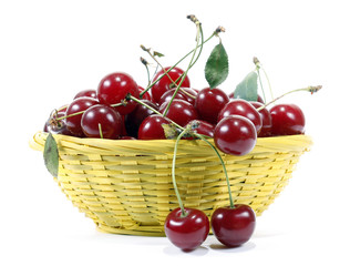 Red cherries in the yellow basket