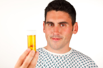 Fototapeta premium Patient holding pills and smiling