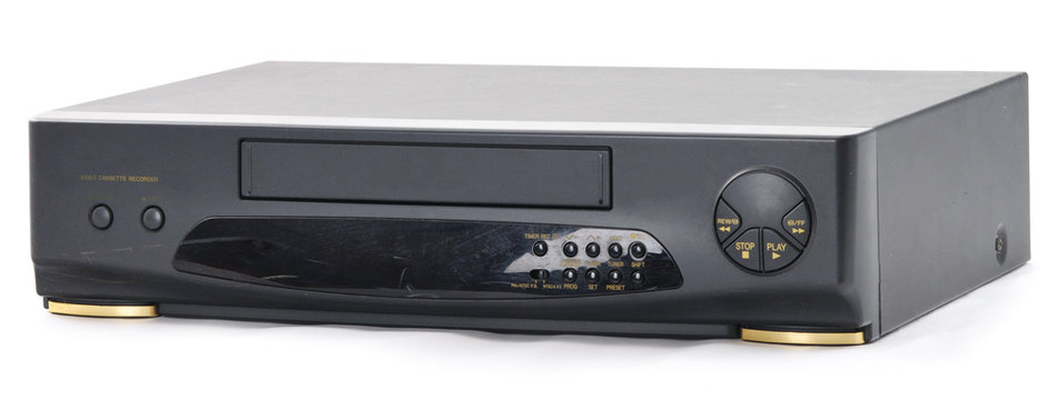 Old video cassette recorder on the white. Front side.
