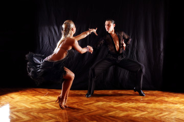 dancers in ballroom against black background - obrazy, fototapety, plakaty