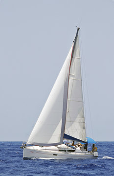 cruising sailboat speeding at open sea