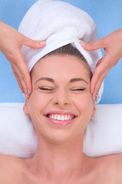 Attractive Young Woman Being Pampered With A Head Massage.