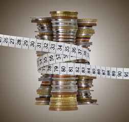 coin towers with measure tape, brown background