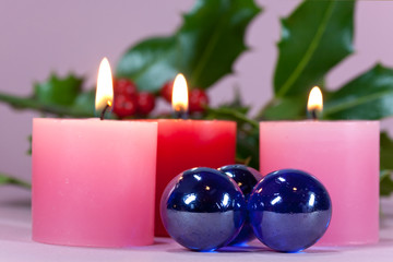 christmas decoration with candle light,holly leaves and berries