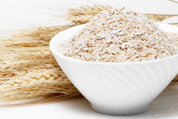 Porridge and Wheat ears on a white background