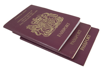 three british passports isolated on white background