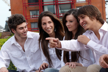 Group of young guys and girls sitting together