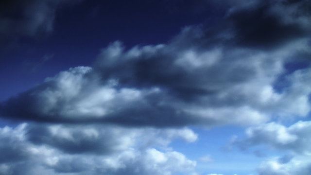 Time lapse of white clouds over blue sky