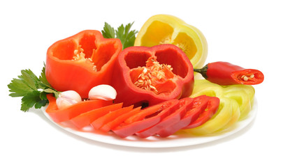 Red, yellow, orange peppers on a plate
