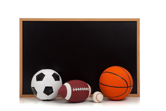 assorted sports balls with a chalkboard background
