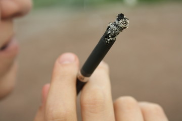 A cigarette in a hand