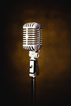 standing retro microphone on the dark brown background