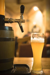 glass of beer with foam and beer butt