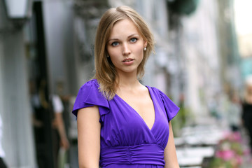 Portrait of a young woman smiling on urban background