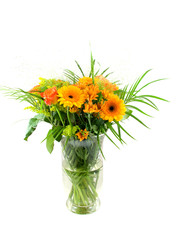 Bouquet of flowers in glass vase over white background