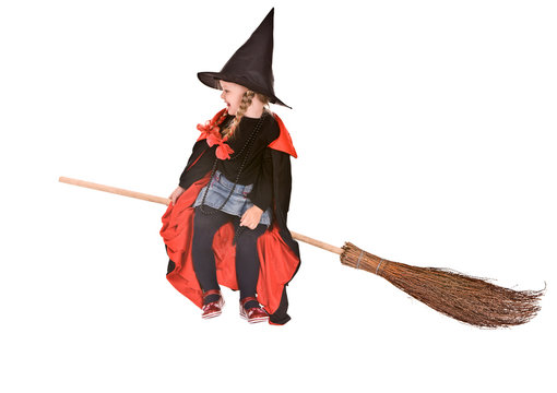 Halloween witch child girl  in black  hat fly on broom.
