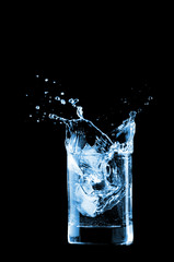 Water in glass isolated on black background
