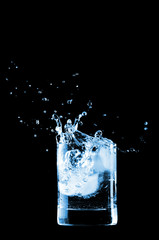 Water in glass isolated on black background