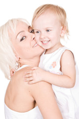 young mother kisses her cute daughter