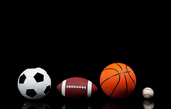 Sports balls on a black background