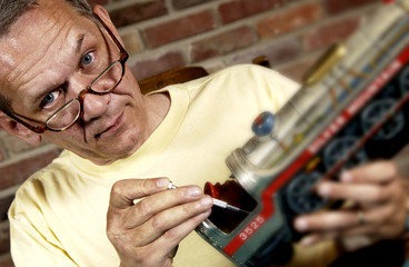 Man repairing a model train