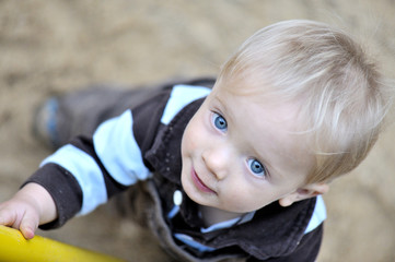 hapy baby playing in the sand