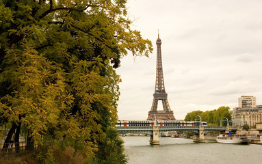 View of the Eiffel tower, moving subway train autumn trees