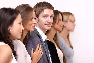 Row of face of four young smiling teens on white background .