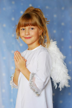 angel girl with hands  folded  to the prayer