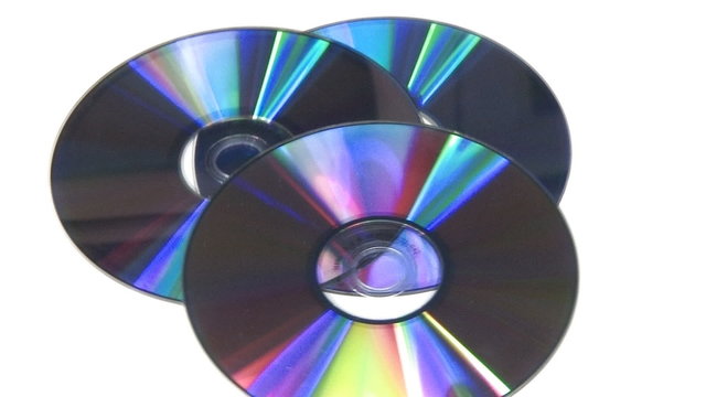 Blue CD DVD rotating on white background