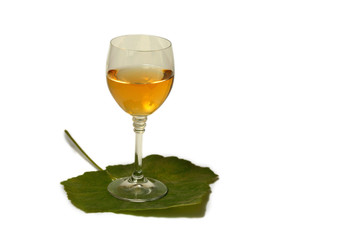 A glass of wine on the grape leaves