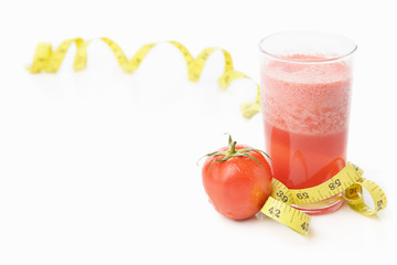 Tomato and juice with measuring tape