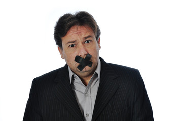 Studio Shot of Business Man told to shut up.