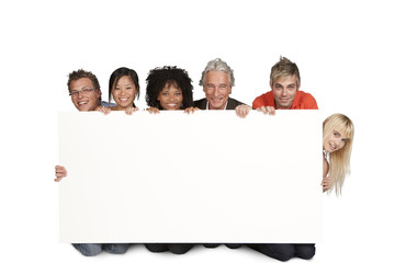 Group of happy students and lecturer holding white board