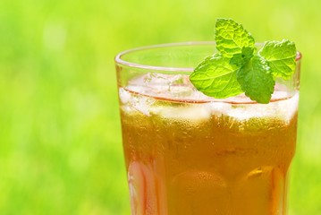 Closeup on glass of cold iced tea at outdoor.