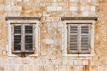 Window shutters on old house on the mediterranean