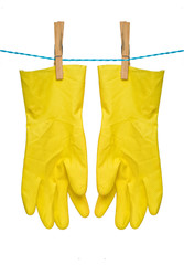 Pair of yellow gloves drying on rope